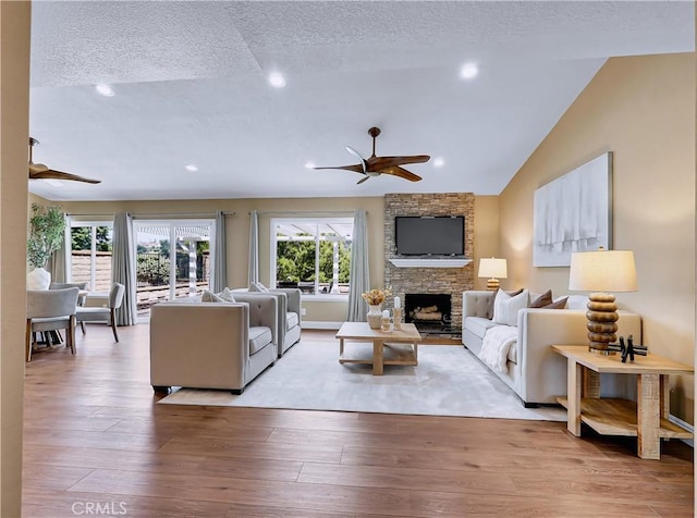 22182 Platino, Mission Viejo, CA 92691 - living room featuring a ceiling fan, a fireplace, wood finished floors, recessed lighting, and a textured ceiling