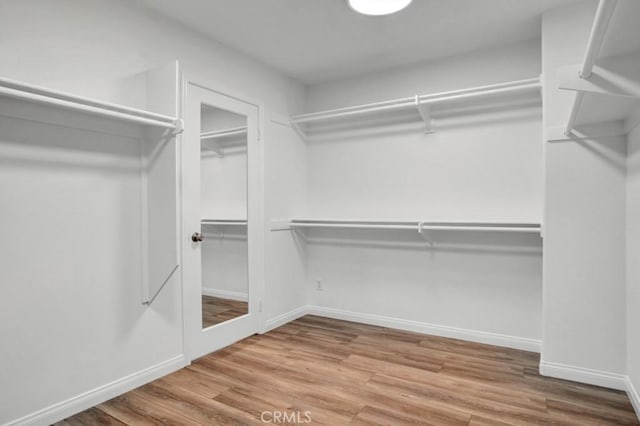 24186 Matthew Pl, Newhall, CA 91321 - walk in closet with wood finished floors
