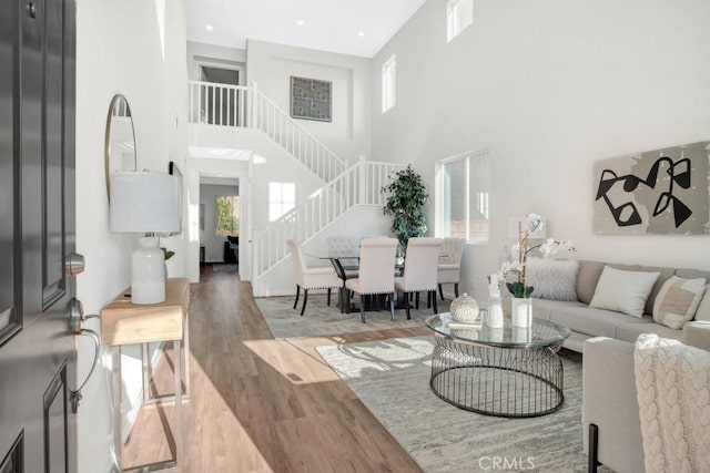 24186 Matthew Pl, Newhall, CA 91321 - living room with a towering ceiling, stairway, and wood finished floors