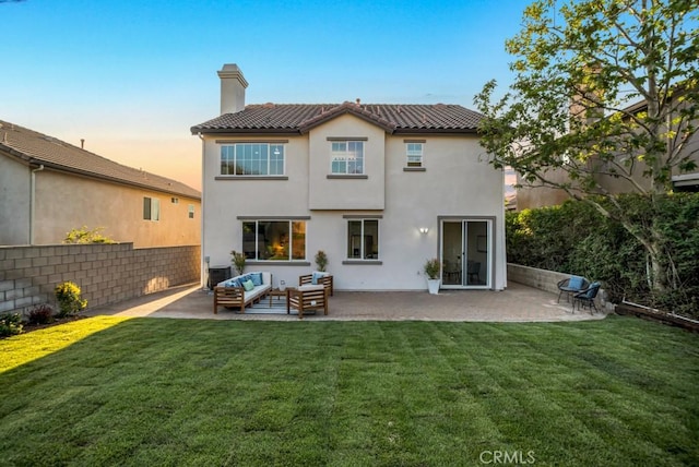 24186 Matthew Pl, Newhall, CA 91321 - back of house featuring a chimney, stucco siding, an outdoor hangout area, a patio area, and a tile roof