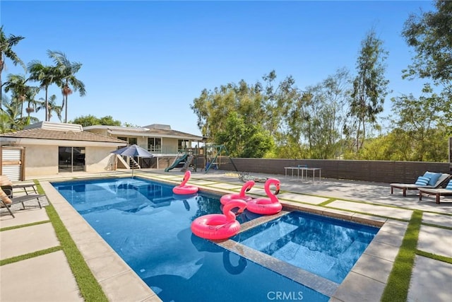 10255 Overhill Dr, Santa Ana, CA 92705 - view of swimming pool with a patio area, a playground, and a fenced backyard