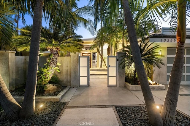 10255 Overhill Dr, Santa Ana, CA 92705 - view of front of house with a gate, a fenced front yard, and stucco siding