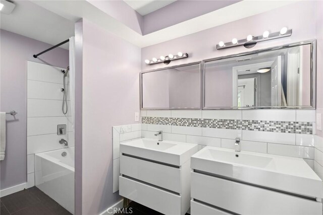 10255 Overhill Dr, Santa Ana, CA 92705 - bathroom with two vanities, backsplash, and bathtub / shower combination