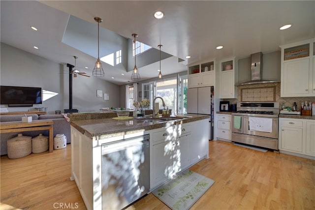 2166 Lopez Dr, Arroyo Grande, CA 93420 - kitchen featuring stainless steel appliances, wall chimney range hood, a center island with sink, light wood-style floors, and recessed lighting