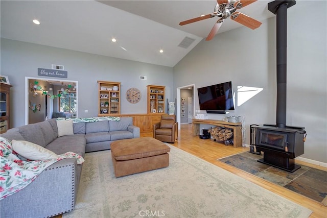 2166 Lopez Dr, Arroyo Grande, CA 93420 - living room with a wood stove, wood finished floors, ceiling fan, high vaulted ceiling, and recessed lighting