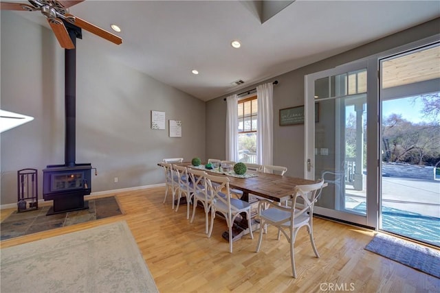 2166 Lopez Dr, Arroyo Grande, CA 93420 - dining area featuring wood finished floors, vaulted ceiling, a wood stove, ceiling fan, and recessed lighting