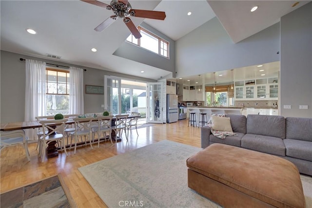 2166 Lopez Dr, Arroyo Grande, CA 93420 - living room featuring healthy amount of natural light, light wood-style flooring, ceiling fan, recessed lighting, and high vaulted ceiling