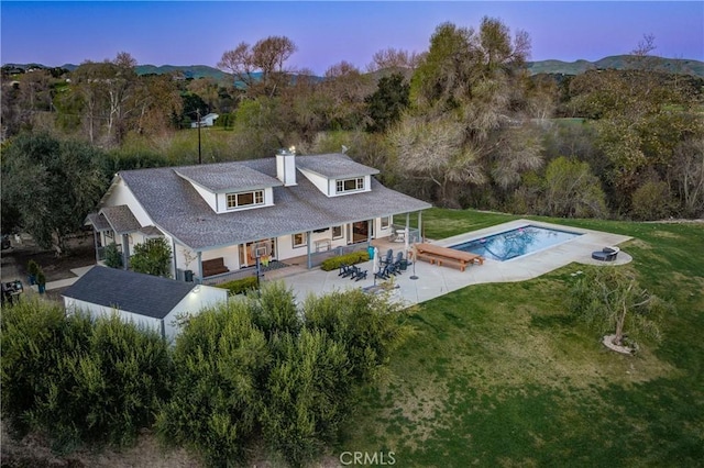 2166 Lopez Dr, Arroyo Grande, CA 93420 - rear view of house with a yard, a chimney, an outdoor pool, and a patio area