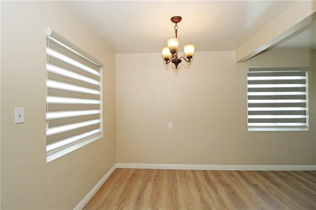 1116 N Center St, Orange, CA 92867 - empty room with a chandelier and light wood-style floors