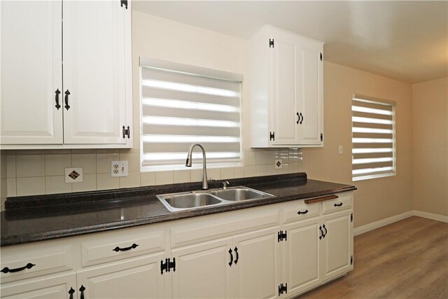 1116 N Center St, Orange, CA 92867 - kitchen with tasteful backsplash, plenty of natural light, white cabinetry, and light wood-style floors