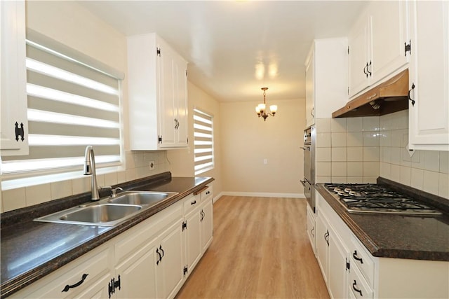1116 N Center St, Orange, CA 92867 - kitchen with appliances with stainless steel finishes, dark countertops, under cabinet range hood, and white cabinetry