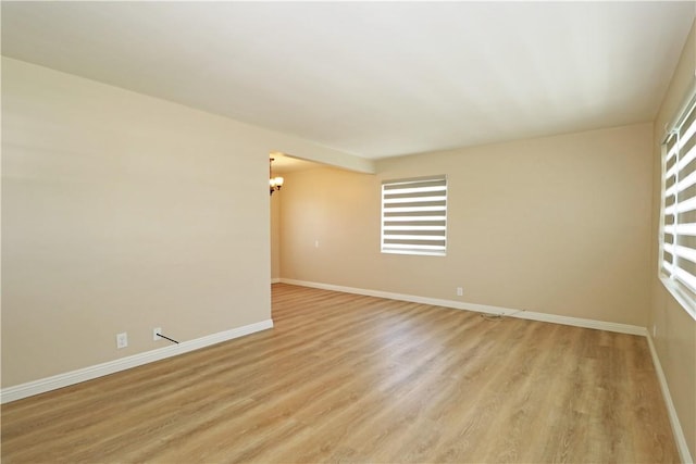 1116 N Center St, Orange, CA 92867 - empty room featuring light wood-style floors, a chandelier, and plenty of natural light