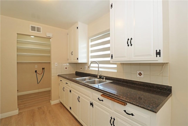 1116 N Center St, Orange, CA 92867 - kitchen featuring light wood-style flooring, tasteful backsplash, and white cabinets