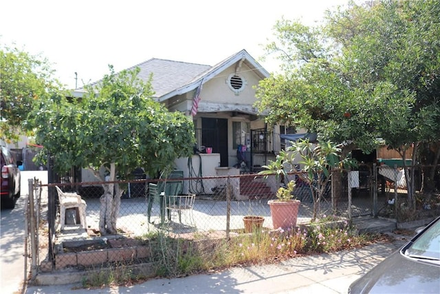 164 N Townsend Ave, City Terrace, CA 90063 - view of property hidden behind natural elements featuring a fenced front yard and roof with shingles