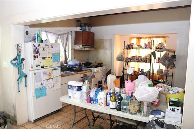164 N Townsend Ave, City Terrace, CA 90063 - kitchen featuring white appliances, tile patterned floors, and under cabinet range hood