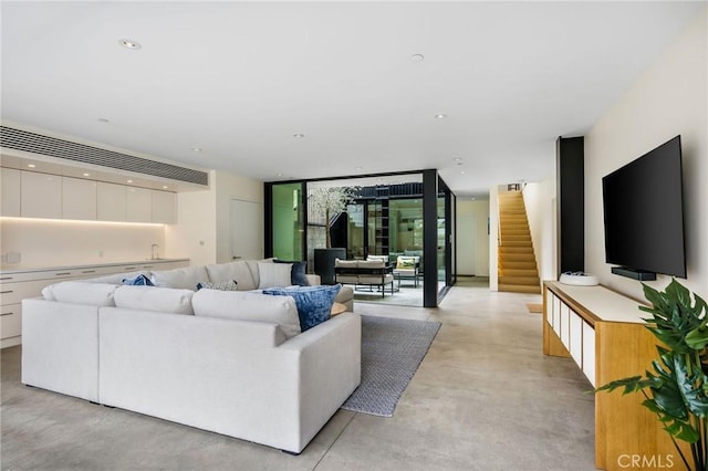2821 Alma Ave, Manhattan Beach, CA 90266 - living area featuring concrete flooring, a wall of windows, and stairs