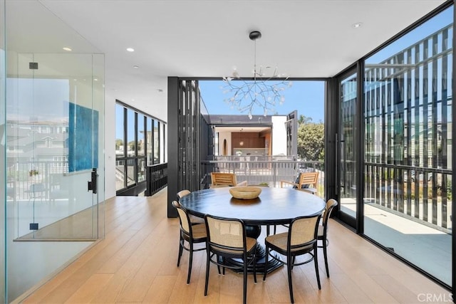 2821 Alma Ave, Manhattan Beach, CA 90266 - dining space with floor to ceiling windows, wood finished floors, and a chandelier