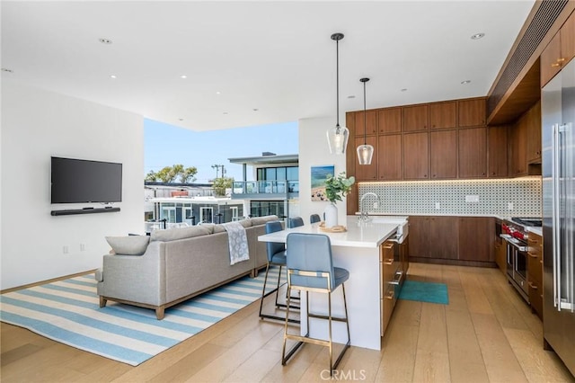 2821 Alma Ave, Manhattan Beach, CA 90266 - kitchen featuring decorative backsplash, light wood-type flooring, premium appliances, and light countertops