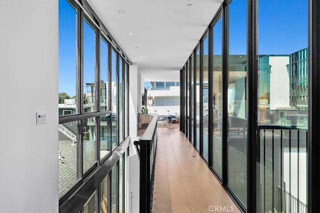 2821 Alma Ave, Manhattan Beach, CA 90266 - hallway with a wall of windows and wood finished floors