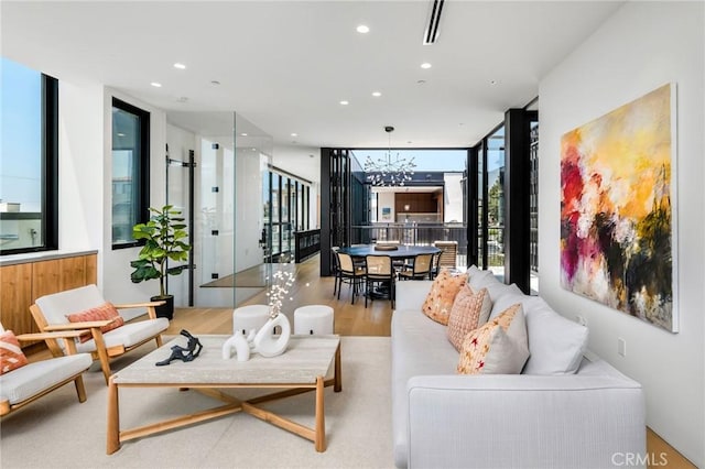 2821 Alma Ave, Manhattan Beach, CA 90266 - living room featuring expansive windows, a chandelier, recessed lighting, wood finished floors, and stairs