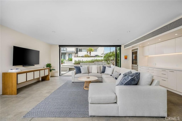 2821 Alma Ave, Manhattan Beach, CA 90266 - living room with healthy amount of natural light, concrete floors, beverage cooler, and a wall of windows