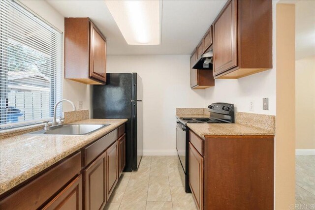 955 Amistad Pl Unit C, El Cajon, CA 92019 - kitchen with black appliances, under cabinet range hood, and light tile patterned floors