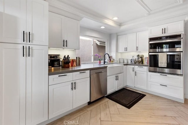 1174 Kingston St, Costa Mesa, CA 92626 - kitchen with appliances with stainless steel finishes, backsplash, white cabinets, recessed lighting, and ornamental molding