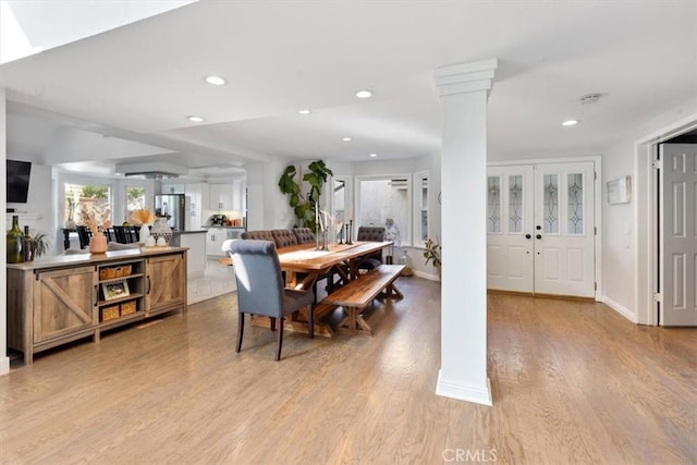1174 Kingston St, Costa Mesa, CA 92626 - dining space with recessed lighting, light wood-style flooring, and decorative columns