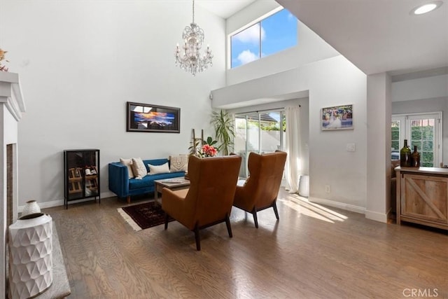 1174 Kingston St, Costa Mesa, CA 92626 - dining room featuring wood finished floors, a chandelier, a towering ceiling, and recessed lighting