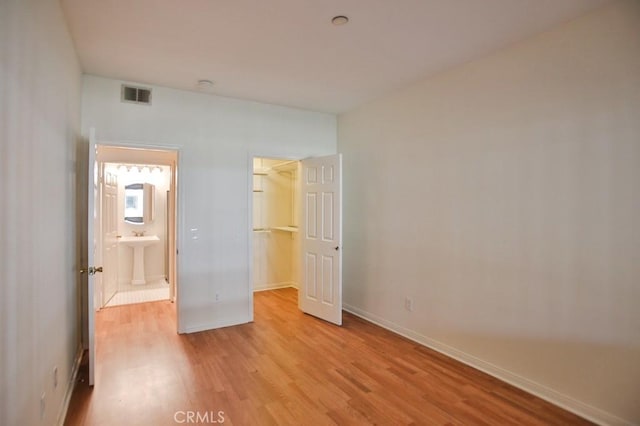 11600 Warner Ave Unit 428, Fountain Valley, CA 92708 - unfurnished bedroom with a spacious closet, light wood finished floors, and a closet