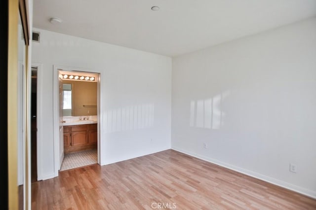 11600 Warner Ave Unit 428, Fountain Valley, CA 92708 - unfurnished bedroom featuring light wood-style flooring and ensuite bathroom