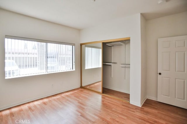 11600 Warner Ave Unit 428, Fountain Valley, CA 92708 - unfurnished bedroom featuring a closet and wood finished floors