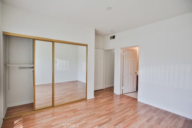 11600 Warner Ave Unit 428, Fountain Valley, CA 92708 - unfurnished bedroom with wood finished floors and a closet