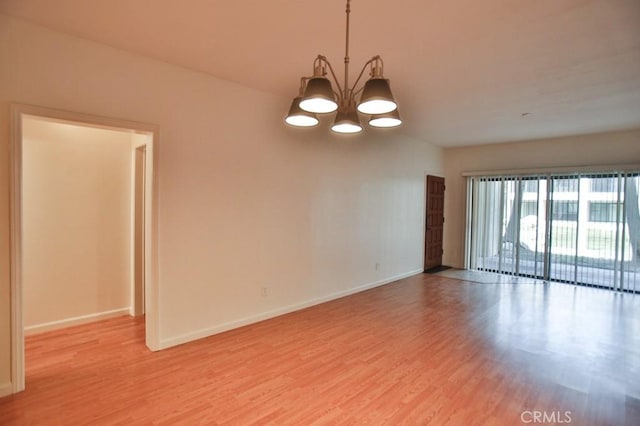 11600 Warner Ave Unit 428, Fountain Valley, CA 92708 - unfurnished room featuring light wood-style floors and a chandelier