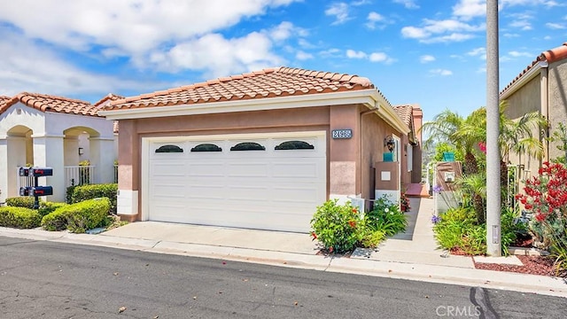 24965 Seagate, Dana Point, CA 92629 - mediterranean / spanish-style house with an attached garage, concrete driveway, stucco siding, and a tile roof