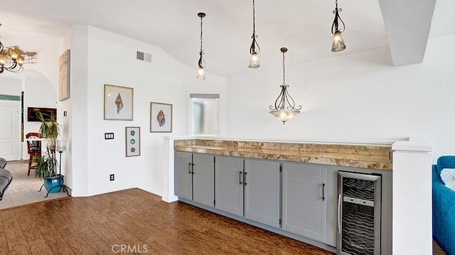 24965 Seagate, Dana Point, CA 92629 - kitchen featuring wine cooler, gray cabinets, lofted ceiling, dark wood-type flooring, and decorative light fixtures