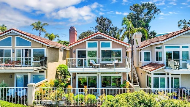 24965 Seagate, Dana Point, CA 92629 - rear view of property featuring a chimney, a tiled roof, stucco siding, and a sunroom