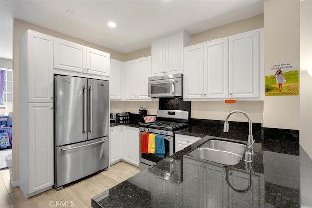 1152 Newberry Ln, Claremont, CA 91711 - kitchen featuring stainless steel appliances, dark stone counters, white cabinets, light wood-style flooring, and recessed lighting