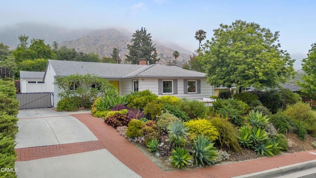 455 E Laurel Ave, Sierra Madre, CA 91024 - single story home featuring a gate, a mountain view, decorative driveway, and a chimney