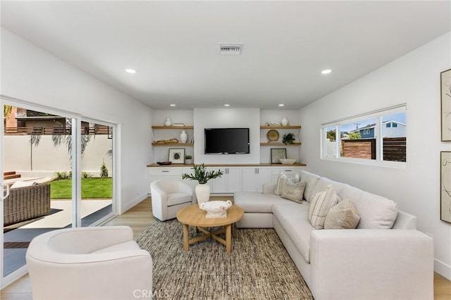 245 Surf Pl, Seal Beach, CA 90740 - living room with recessed lighting and light wood-style flooring