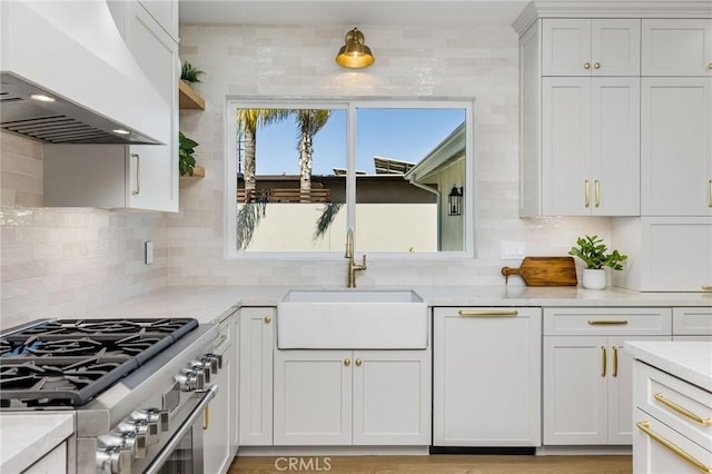 245 Surf Pl, Seal Beach, CA 90740 - kitchen with stainless steel range, backsplash, light countertops, premium range hood, and white cabinets