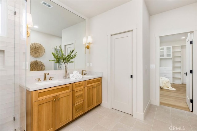 245 Surf Pl, Seal Beach, CA 90740 - full bath featuring double vanity, tile patterned flooring, a stall shower, and a spacious closet