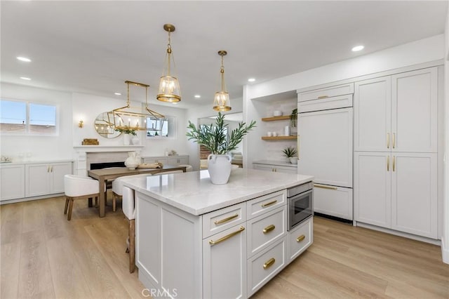 245 Surf Pl, Seal Beach, CA 90740 - kitchen with built in appliances, light wood-style floors, open shelves, recessed lighting, and a kitchen island