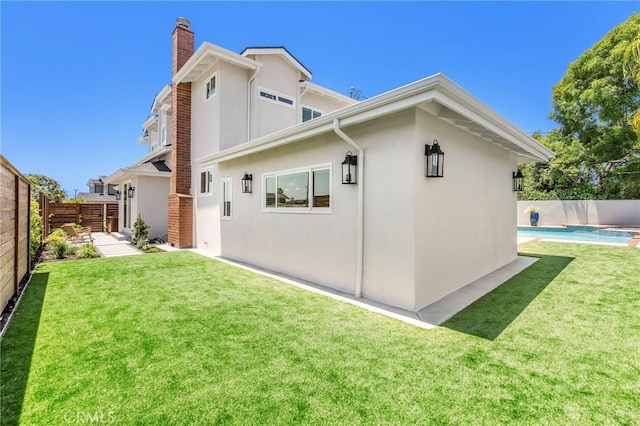 245 Surf Pl, Seal Beach, CA 90740 - back of property with a chimney, stucco siding, and a fenced backyard