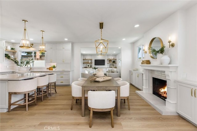 245 Surf Pl, Seal Beach, CA 90740 - dining room featuring light wood finished floors, a fireplace, and recessed lighting