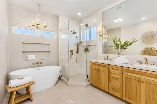 245 Surf Pl, Seal Beach, CA 90740 - bathroom featuring a stall shower, a freestanding tub, double vanity, a chandelier, and tile patterned flooring