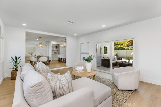 245 Surf Pl, Seal Beach, CA 90740 - living area with recessed lighting, light wood-type flooring, and a chandelier