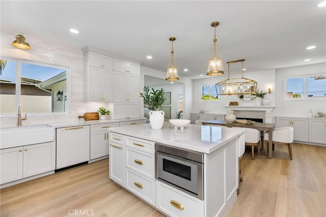 245 Surf Pl, Seal Beach, CA 90740 - kitchen featuring white dishwasher, light wood-style floors, white cabinetry, decorative light fixtures, and recessed lighting