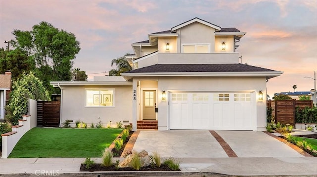 245 Surf Pl, Seal Beach, CA 90740 - view of front facade with driveway, an attached garage, and stucco siding
