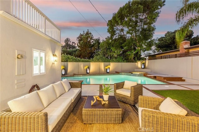 245 Surf Pl, Seal Beach, CA 90740 - pool at dusk featuring an outdoor living space, an in-ground hot tub, and a fenced backyard